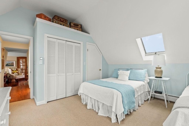 107 Channel Point Rd, Barnstable, MA 02601 - bedroom with vaulted ceiling, a baseboard radiator, a skylight, a closet, and carpet flooring