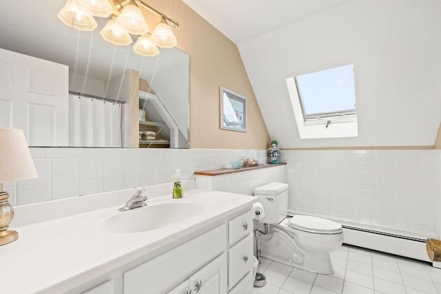 107 Channel Point Rd, Barnstable, MA 02601 - full bath with tile walls, a baseboard radiator, a skylight, vanity, and tile patterned floors