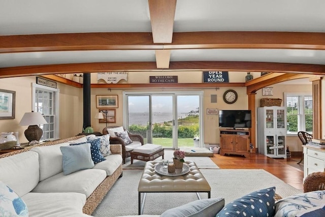 107 Channel Point Rd, Barnstable, MA 02601 - living area with beam ceiling, wood finished floors, plenty of natural light, and a wood stove