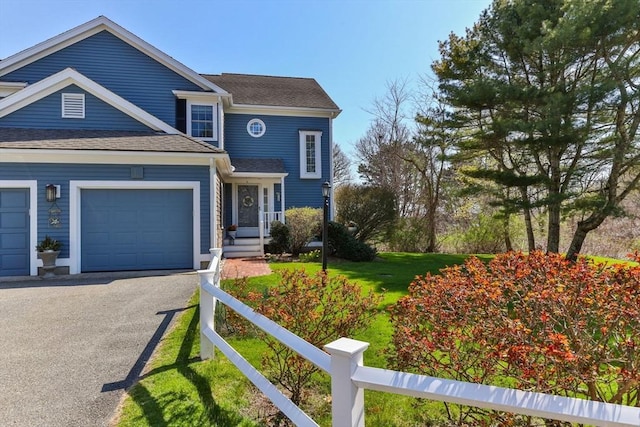 2 Englewood Dr Unit Jl, Harwich, MA 02645 - view of front of property featuring an attached garage, roof with shingles, a front lawn, and asphalt driveway