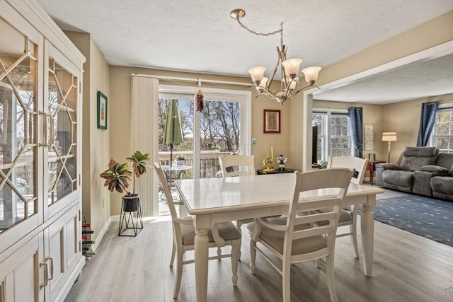 2 Englewood Dr Unit Jl, Harwich, MA 02645 - dining room with a chandelier, light wood-style floors, and baseboards