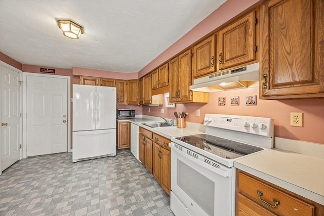 2 Englewood Dr Unit Jl, Harwich, MA 02645 - kitchen featuring white appliances, under cabinet range hood, a sink, brown cabinets, and light countertops