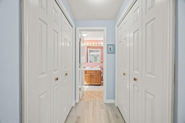2 Englewood Dr Unit Jl, Harwich, MA 02645 - hall featuring light wood finished floors, a textured ceiling, and baseboards