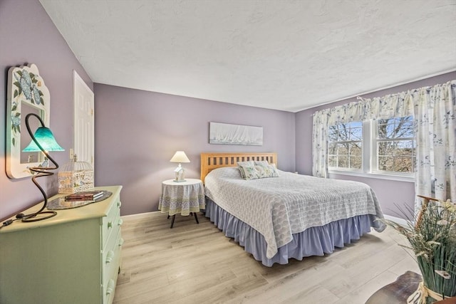 2 Englewood Dr Unit Jl, Harwich, MA 02645 - bedroom featuring light wood-type flooring, a textured ceiling, and baseboards