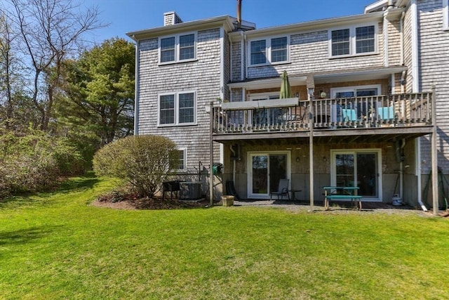 2 Englewood Dr Unit Jl, Harwich, MA 02645 - rear view of house with a lawn, a wooden deck, a chimney, and central air condition unit