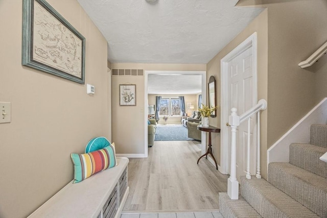 2 Englewood Dr Unit Jl, Harwich, MA 02645 - corridor with a textured ceiling, stairway, baseboards, and wood finished floors