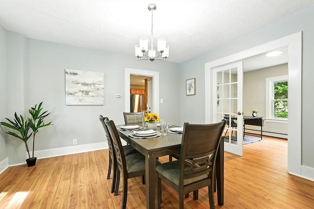 29 Healy St, West Springfield, MA 01089 - dining space with a chandelier and light wood-style flooring