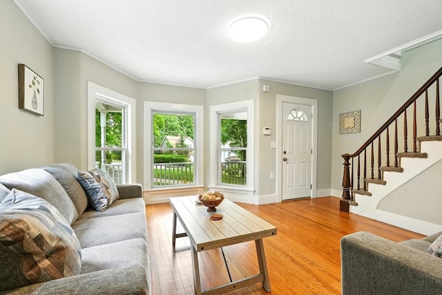 29 Healy St, West Springfield, MA 01089 - living area featuring ornamental molding, light wood-style floors, and stairs