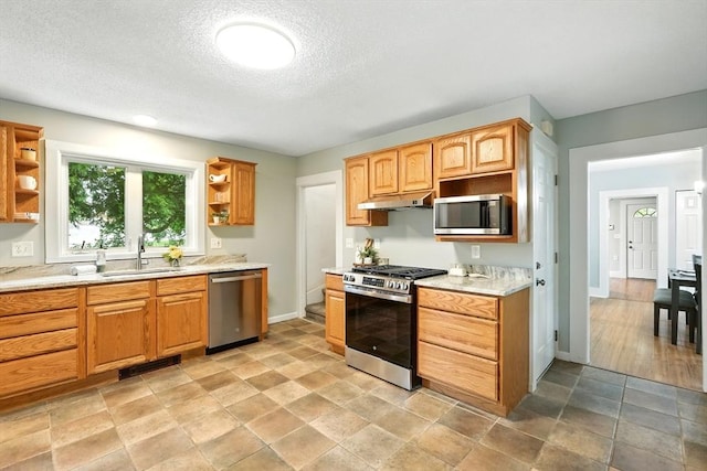 29 Healy St, West Springfield, MA 01089 - kitchen featuring stainless steel appliances, open shelves, under cabinet range hood, light countertops, and a textured ceiling