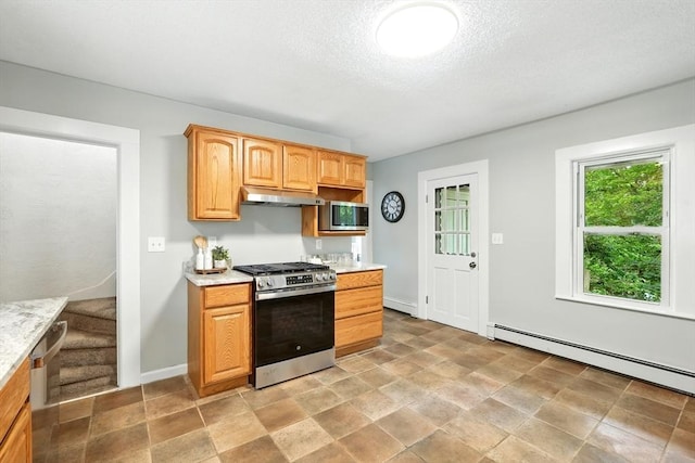 29 Healy St, West Springfield, MA 01089 - kitchen with stainless steel appliances, under cabinet range hood, baseboard heating, light stone finish flooring, and a textured ceiling