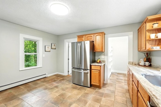 29 Healy St, West Springfield, MA 01089 - kitchen featuring freestanding refrigerator, open shelves, baseboard heating, a textured ceiling, and light stone countertops