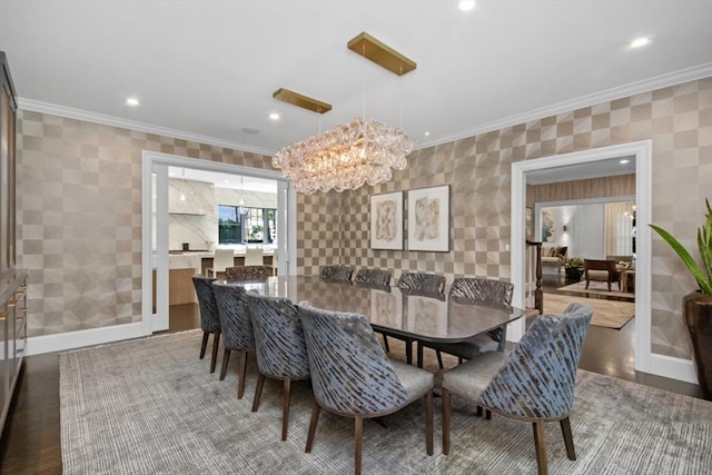 dining room featuring a chandelier, ornamental molding, baseboards, and recessed lighting