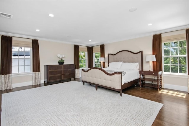 bedroom with multiple windows, visible vents, and baseboards