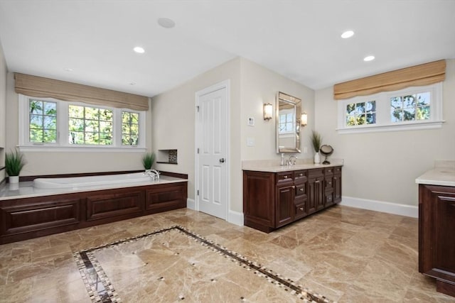 full bath with marble finish floor, vanity, recessed lighting, baseboards, and a bath