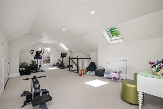 exercise room featuring carpet floors, recessed lighting, and vaulted ceiling with skylight