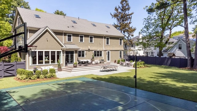 back of house featuring a yard, french doors, a fenced backyard, and basketball hoop