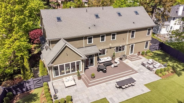 back of property featuring a yard, a patio, a fenced backyard, an outdoor living space with a fire pit, and outdoor dining area