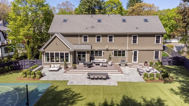 back of house featuring a patio, a fenced backyard, a lawn, an outdoor hangout area, and a shingled roof