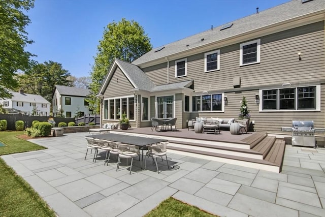 back of house featuring outdoor lounge area, a patio area, outdoor dining area, and fence
