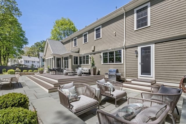rear view of property with an outdoor living space, a deck, and outdoor dining area