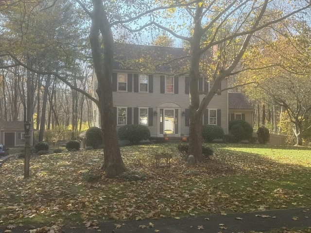 colonial-style house with a front lawn