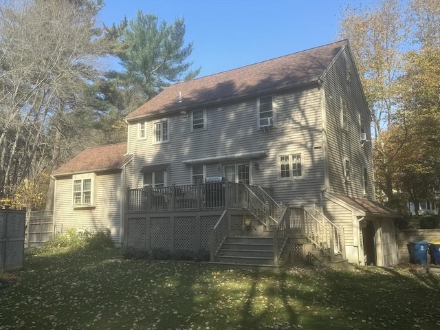 rear view of property featuring a yard and a wooden deck