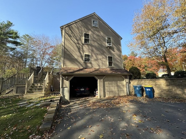 view of side of home with a garage and a wooden deck