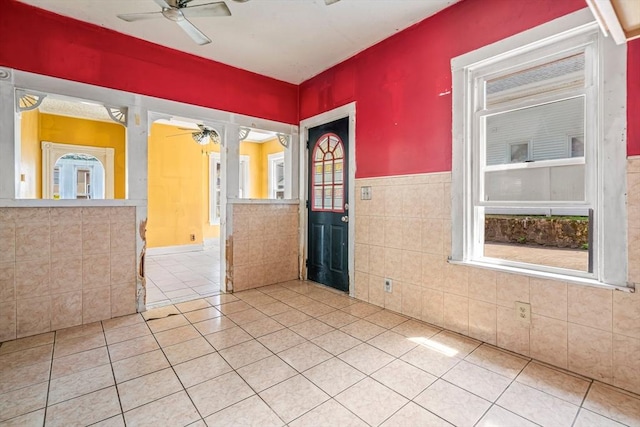 24 N Byron Ave, Brockton, MA 02301 - unfurnished room with ceiling fan, tile walls, light tile patterned floors, and wainscoting