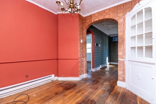 empty room featuring dark wood-type flooring, a baseboard heating unit, built in features, and ornamental molding