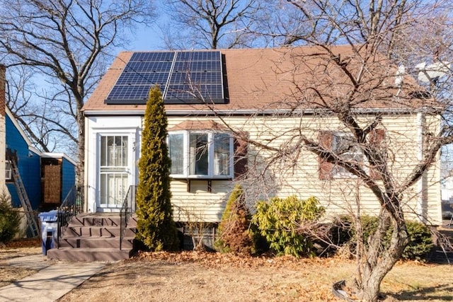 view of front facade featuring solar panels