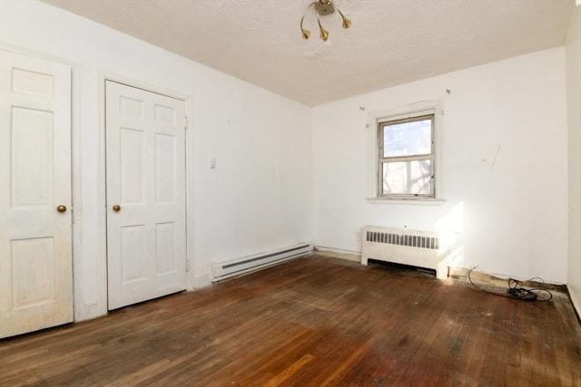 unfurnished room featuring radiator, a baseboard heating unit, and dark hardwood / wood-style flooring