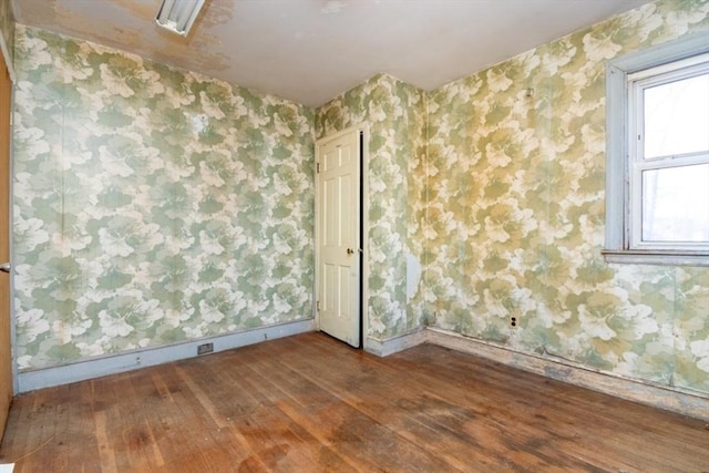 empty room with hardwood / wood-style flooring