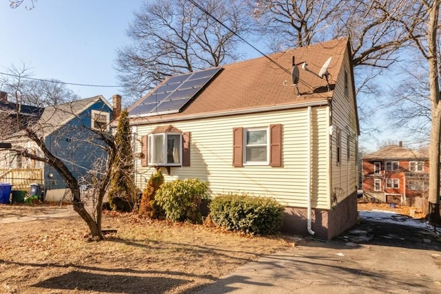 view of property exterior with solar panels