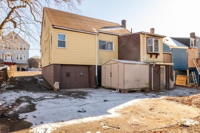 back of property featuring a garage