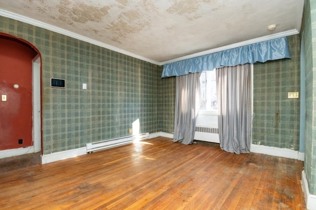 unfurnished room featuring wood-type flooring, radiator, a baseboard heating unit, and crown molding