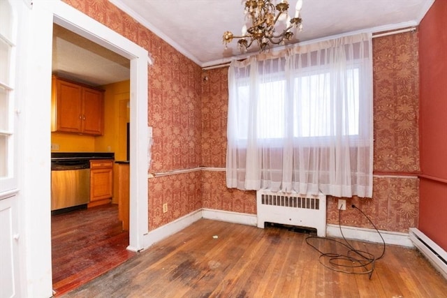 unfurnished dining area with a baseboard radiator, radiator, an inviting chandelier, ornamental molding, and hardwood / wood-style flooring