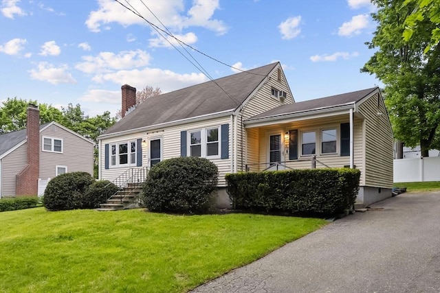 view of front of property with a front lawn and a chimney