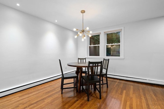 dining area with a chandelier, a baseboard radiator, wood finished floors, and recessed lighting