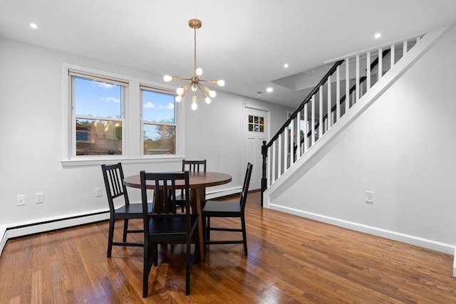 dining space with a chandelier, baseboards, wood finished floors, recessed lighting, and stairway