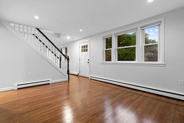 entrance foyer with a baseboard radiator, stairs, baseboard heating, wood finished floors, and recessed lighting