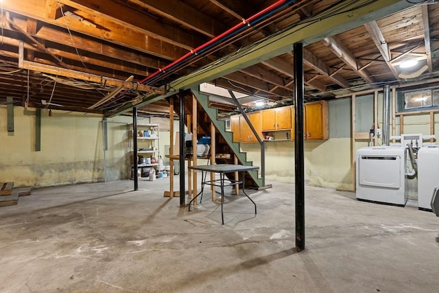 unfinished below grade area with washing machine and clothes dryer and stairway