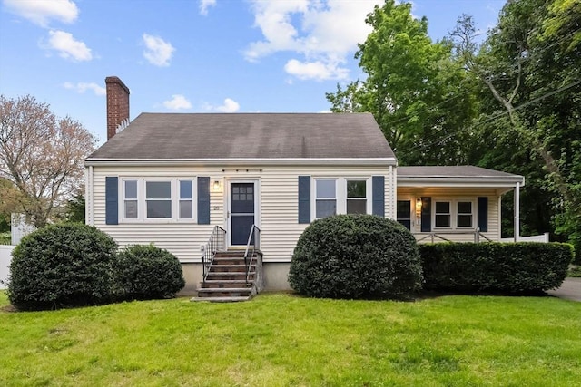 cape cod house featuring entry steps, a chimney, and a front lawn