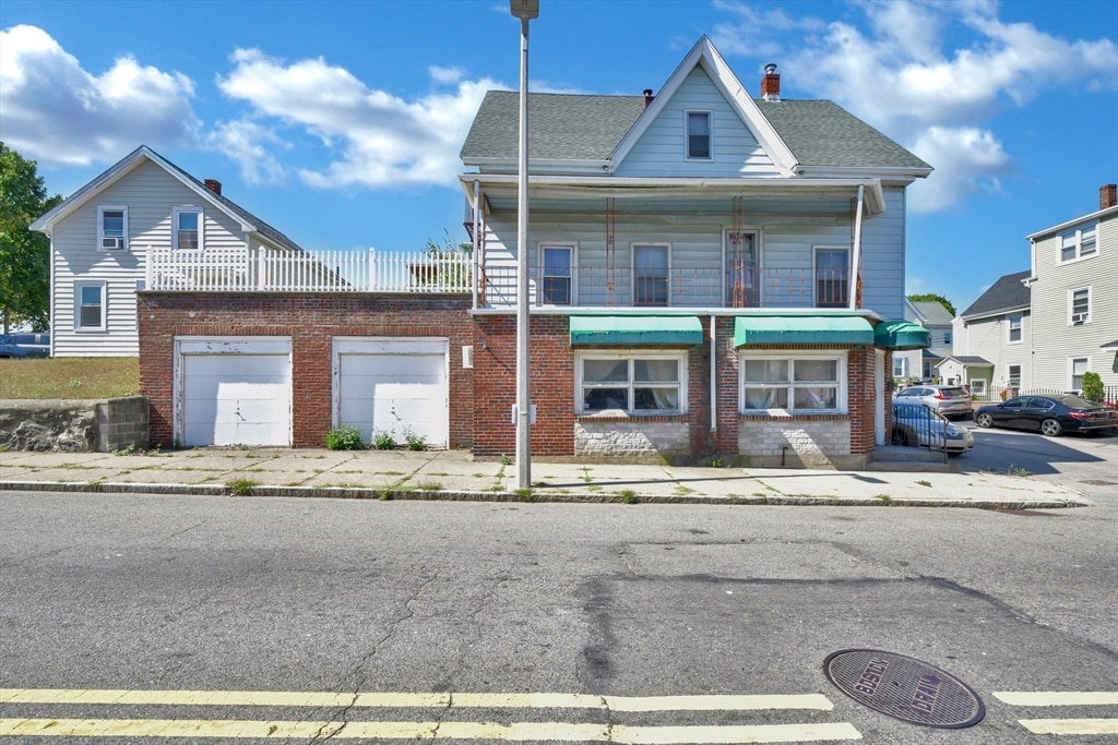 view of front of home featuring a balcony and a garage