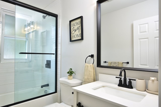 full bathroom with toilet, combined bath / shower with glass door, and vanity