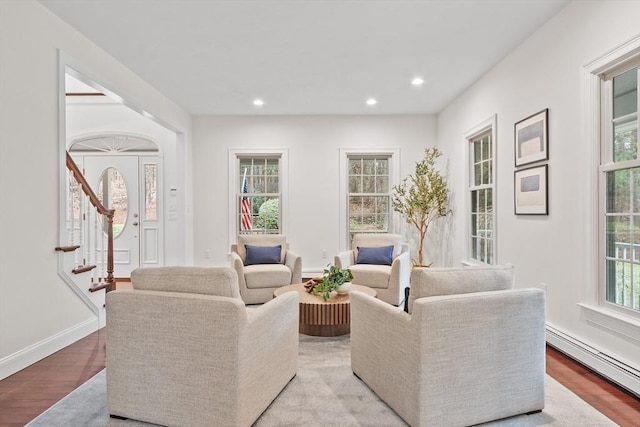 living room featuring baseboard heating and light hardwood / wood-style flooring