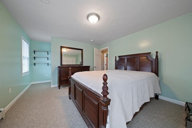 bedroom with a baseboard radiator and light carpet