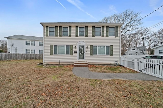 colonial home with a front lawn