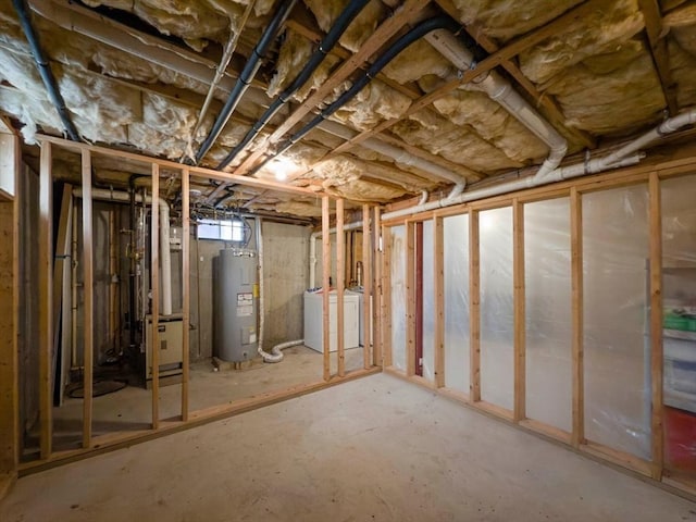 basement featuring washer and dryer and water heater