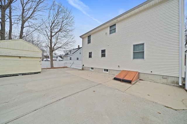 view of home's exterior featuring an outbuilding and a patio area