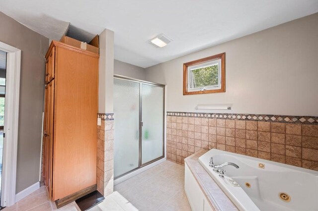 146 Field St, Taunton, MA 02780 - bathroom with tile walls, a shower stall, a tub with jets, tile patterned floors, and a wainscoted wall
